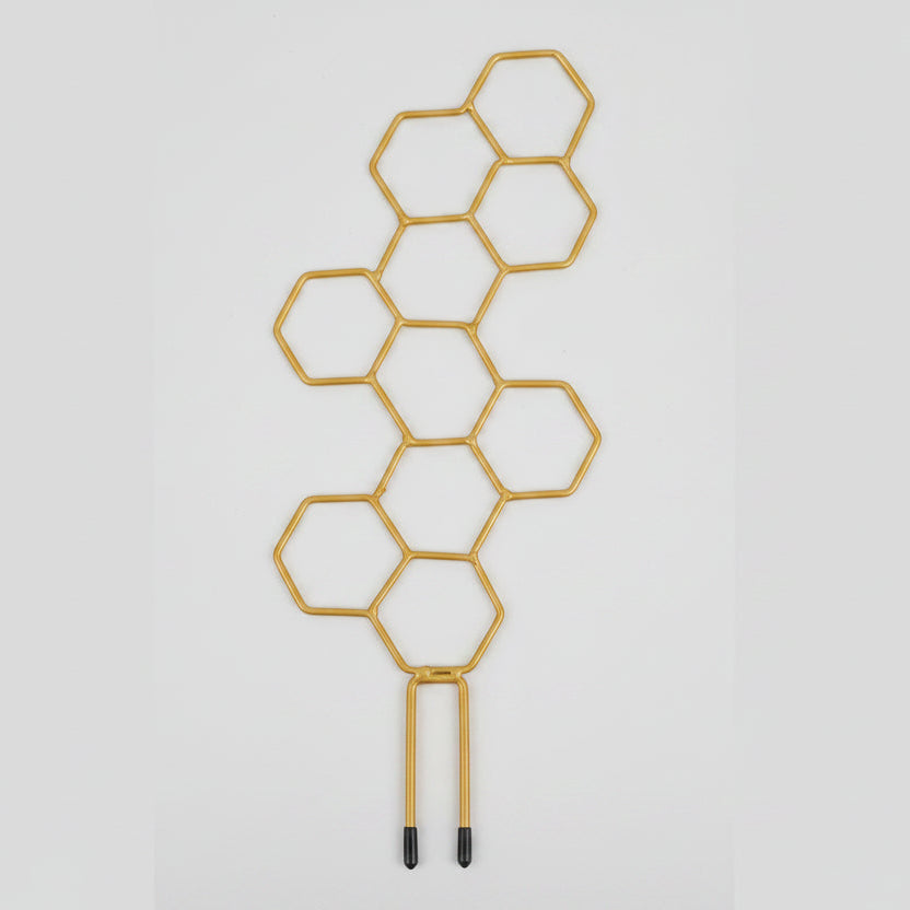 Gold honeycomb plant holder with a potted plant on a white background, showing product size.